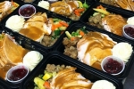 Trays of turkey, mashed potatoes, veggies, stuffing and cranberry sauce